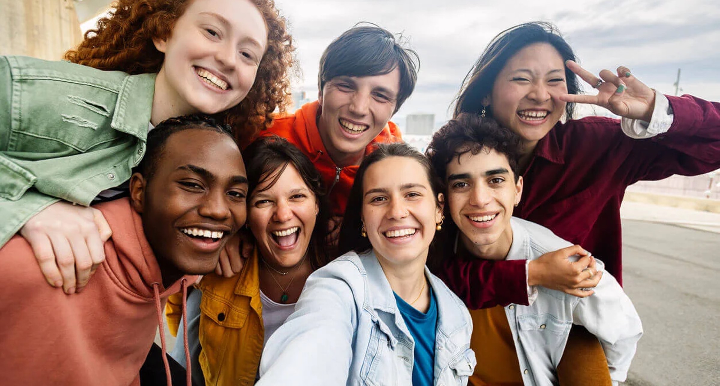 Diverse group of young students smiling and posing together